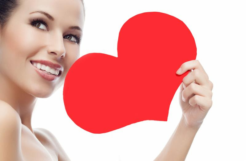 beauty portrait of attractive  caucasian smiling young woman isolated on white studio shot face skin red heart valentine s love